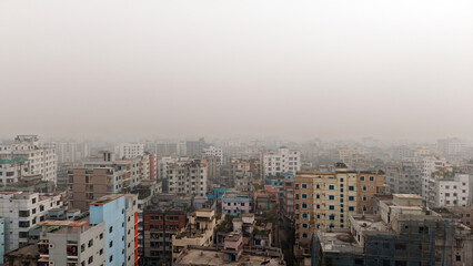 Dense cityscape with numerous buildings on a hazy day city urban architecture haze smog skyscrapers