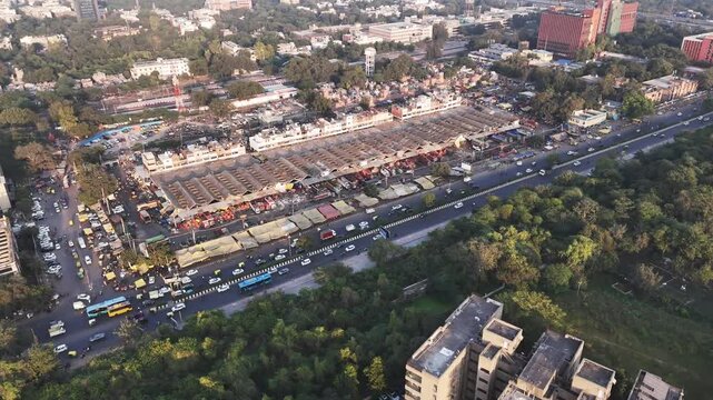 Drone shot over Okhla Mandi captures the organized chaos of one of Delhi&rsquo;s largest markets, with endless stalls, moving traffic, and urban life framed by green surroundings.