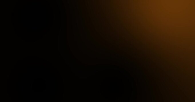 4K Black and gold brown Abstract Gradient Background. Dark blurred tones fading warm golden light, creating a moody cinematic backdrop with smooth transitions. Elegant, minimal design. Seamless loopab