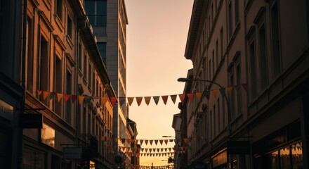 Sunset illuminates a narrow street lined with old buildings, festive bunting strung overhead