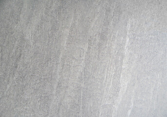 Neutral gray textured surface with subtle concrete or plaster patterns