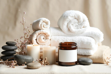Luxury Spa Still Life with White Towels, Aromatherapy Candle, Volcanic Stones, and Dried Botanicals in a Calm Wellness Setting