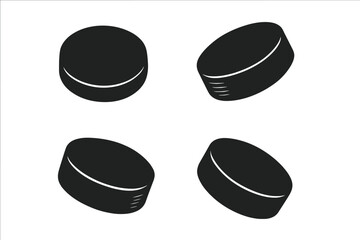 Four Dark Hockey Pucks on a Dark Background