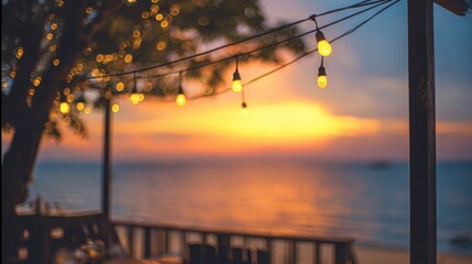 Blurred bokeh lights at sunset with yellow string decor in beach restaurant, warm evening glow and romantic outdoor dining atmosphere for travel, hospitality, leisure and lifestyle background