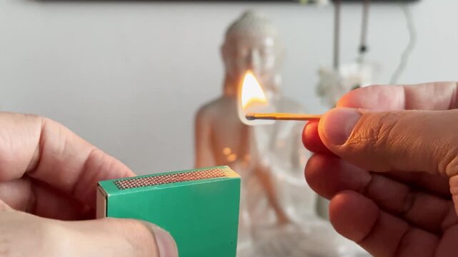 Lighting a Match to Ignite a Candle in a Calm Meditation Space
