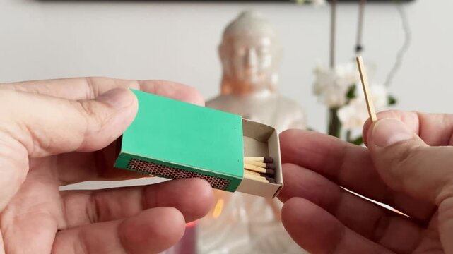 Lighting a Match to Ignite a Candle in a Calm Meditation Space

