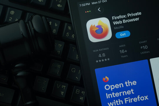 Dhaka, Bangladesh- 28 Oct 2025: An iPad displaying the Firefox app against a judge's gavel and dark keyboard background.