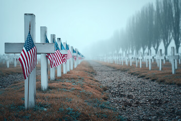 Empty military cemetery at dawn with rows of white crosses and flags marking the graves
