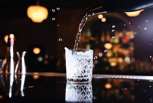 Elegant liquor pouring into a crystal glass on a bar top, creating a dynamic splash effect,