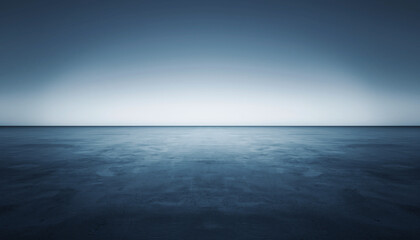 Fototapeta premium Calm ocean waters under a serene blue gradient sky