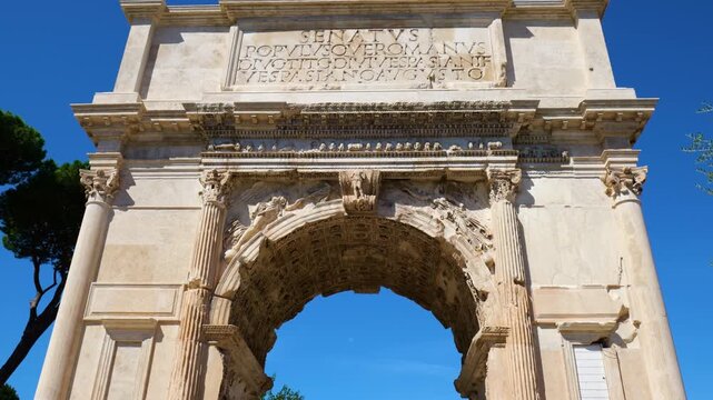 arch titus rome italy towering corinthian columns coffered archway winged reliefs warrior keystone latin inscriptions under vivid blue sky of coffer roman architecture 