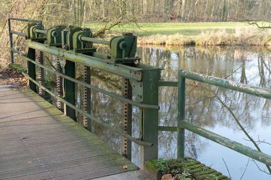 Sluice gate mechanism on river bridge controlling water flow