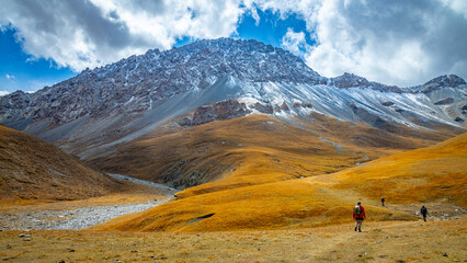 Tian Shan mountains glacier and snow summits on a sunny day with blue sky. Kyrgyzstan mountains on the border with China high altitude snow and glacier trek, climbing and alpinism in the wilderness