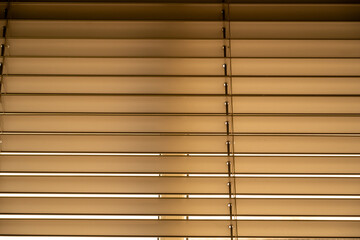 Horizontal metal office window blinds with an evening view 