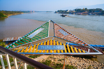 The triangular border marker at the confluence of the Mekong and Ruak rivers in the Golden Triangle Park (Sop Ruak) in Chiang Saen in Northern Thailand