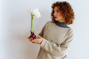 young woman with an amaryllis flower