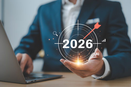 Businessman presenting futuristic AI target for 2026 with laptop - Powered by Adobe