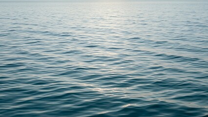 Blue Ocean Water Surface with Gentle Ripples and Shimmering Sunlight Reflections