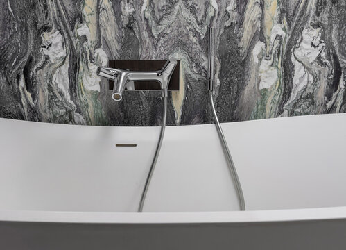 Wall Mounted Bathroom Mixer Tap with Handheld Shower on Cipollino Marble Stone Wall, Modern Luxury Interior Detail, Minimalist Spa Bathroom Design