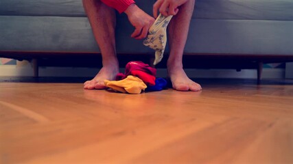 Different socks in legs. Mismatched multicolored socks on feet man. Men's legs in Different socks as symbol of down syndrome. Down syndrome awareness concept. Wear Mismatched Socks. Disabled person.