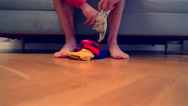 Different socks in legs. Mismatched multicolored socks on feet man. Men's legs in Different socks as symbol of down syndrome. Down syndrome awareness concept. Wear Mismatched Socks. Disabled person.