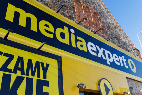 Zarow, Poland &ndash; December 26, 2025: Media Expert store sign mounted on a historic brick and stone building facade.