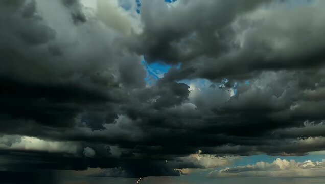 Cinematic 4K footage of sudden intense storm forming rapidly the sky with dark ominous clouds swallowing the remaining patches of blue creating dramatic moody weather scene perfect 