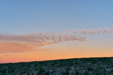Evening clouds above the Holmstadjordet Field, Toten, Norway, in December 2025.