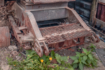 A fragment of an old abandoned mechanism on a summer day
