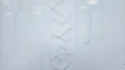 Cracks have appeared in the plaster wall at joints of columns. They are small, hairline cracks....