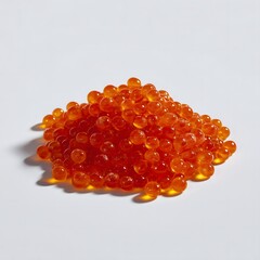 Pile of orange caviar round and bright scattered on white background
