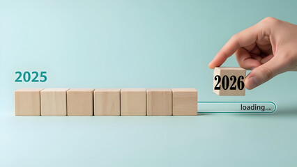 2026 Loading Progress with Wooden Blocks Description: Hand placing a 2026 block next to a digital loading bar. Conceptual image for the arrival of the new year, preparation, and upcoming goals.