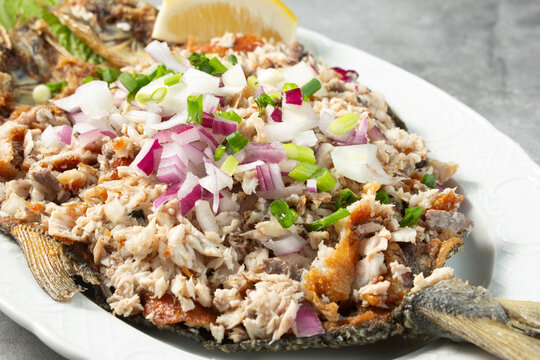 A closeup view of a plate of bangus sisig.