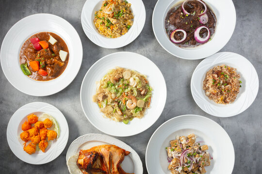 A top down view of several Filipino entrees.