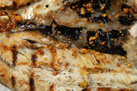 A top down view of plate of grilled bangus, as a background.