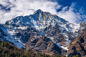 Sharp pyramidal peak of Annapurna III (7,555 meters) rising above the valley between Upper Pisang and Manang on the Annapurna Circuit in Nepal. Dramatic Himalayan mountain landscape with steep rock 