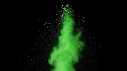 Green powder exploding in air with particles flying around on dark background
