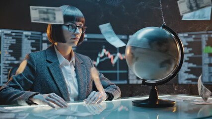 Businesswoman studies financial charts with globe and floating money. Woman analyzes data at desk with globe nearby. Financial analyst works with money floating around globe. Business data analysis. - Powered by Adobe