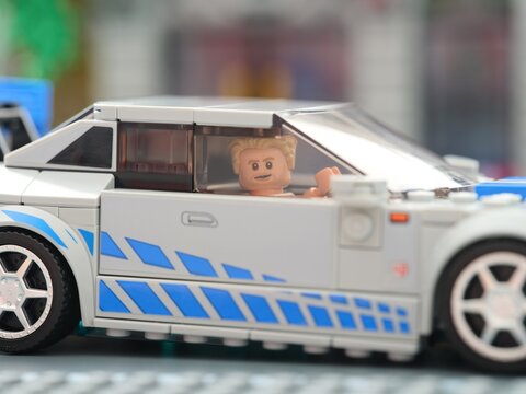 Tambov, Russian Federation - August 21, 2025 Close-up shot of a Lego Speed Champions Nissan Skyline GT-R (R34) car with driver Brian OConner minifigure inside it. 2 Fast 2 Furious movie.