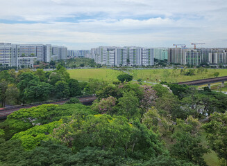 Obraz premium A train passed by the Sun Plaza Park, Tampines heartland district during bloom season - Singapore.