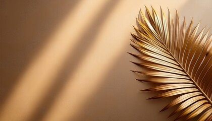 Fototapeta premium A Golden Toned Palm Leaf Casts A Shadow On A Textured Neutral Colored Backdrop