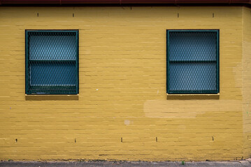 Yellow house with 2 windows, Working class public housing in Woolloomooloo, an, inner-city eastern suburb, Sydney, NSW, Australia