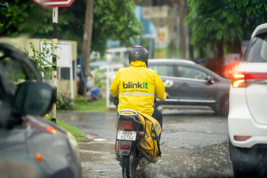 Delivery rider from quick commerce hyper local delivery app Blinkit from Eternal Zomato riding a bike for the last mile delivery showing this new wave of delivery services