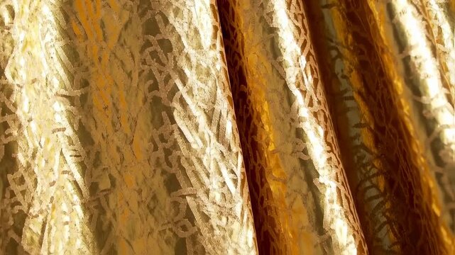 Gold textured fabric with a repeating pattern of etched lines