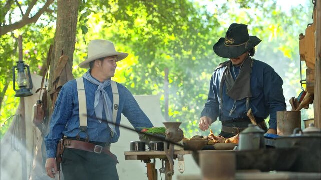 Cowboys gather around a chuck wagon preparing fresh ingredients for cooking