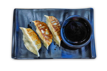 Top view of Gyoza in black plate, focus selective