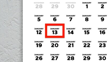 Close-up of the date January 13th marked with a red cursor on the wall calendar 2026