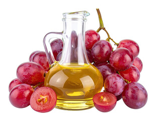 A clear glass bottle filled with golden oil rests amid vibrant red grapes