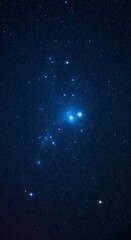 Fototapeta premium Deep space vista reveals a celestial cluster of luminous, blue-tinged points of light. Dark, vast, cosmic panorama