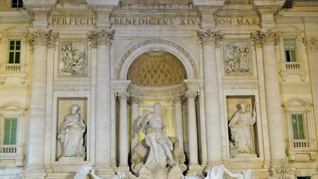 facing symmetrical night trevi fountain facade oceanus beneath coffered arch rich baroque architecture defines front view rome italy roman empire emperor 